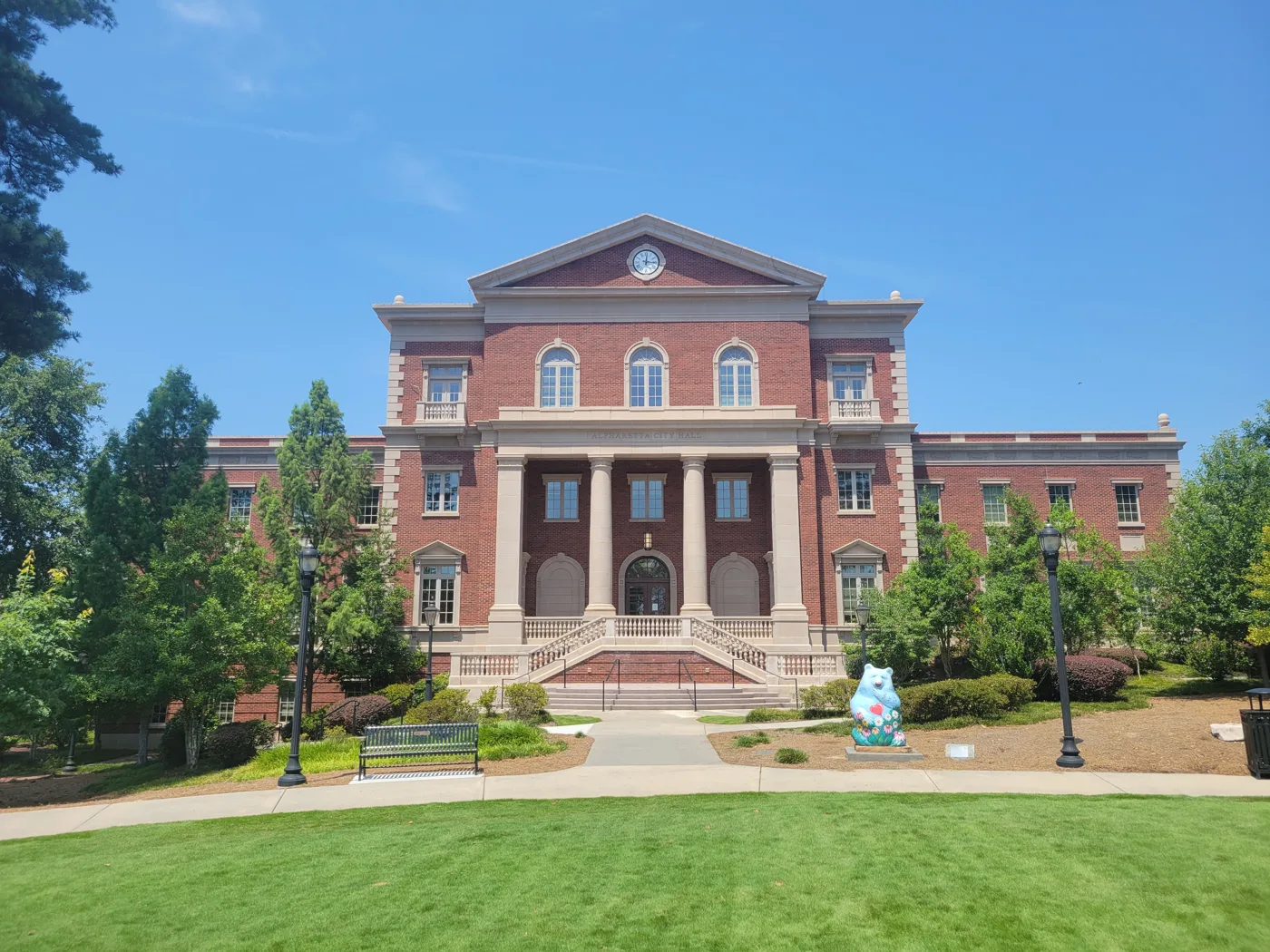 Alpharetta City Hall on Park Plaza. The festival has a City Hall stage, and the City Hall deck is one of its parking options.